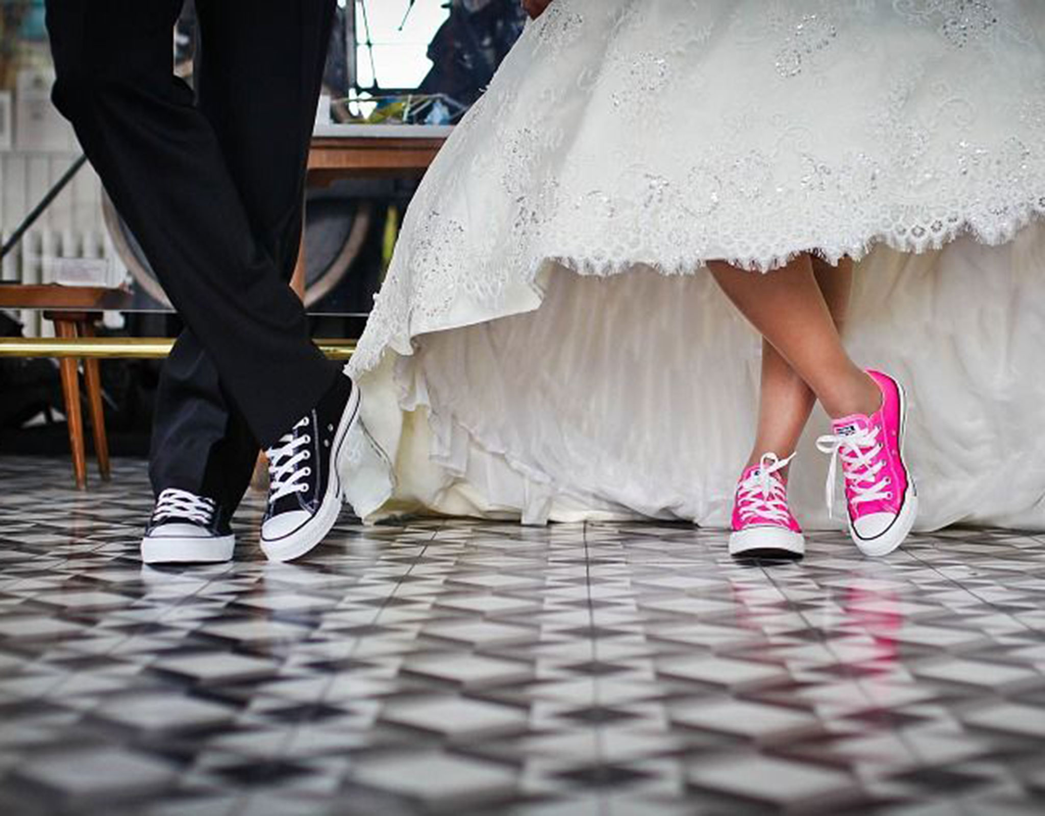 Groom and Bride's legs showing the are wearing Converse All Stars
